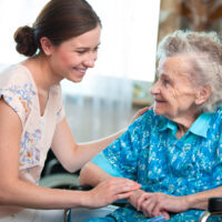 Nurse with senior resident at Assisted Living community, from the Pavilion at the Masonic Homes in California